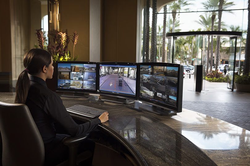 Corporate security control desk with integrated CCTV and access dashboards