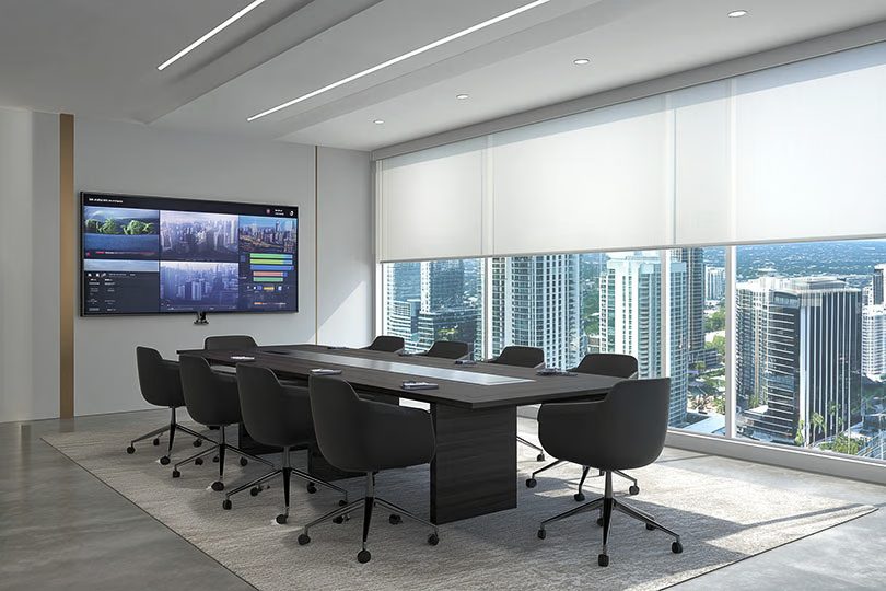Modern conference room with Miami skyline view, with videoconference camera below display