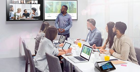 Conference room with video display showing remote participants, Miami corporation